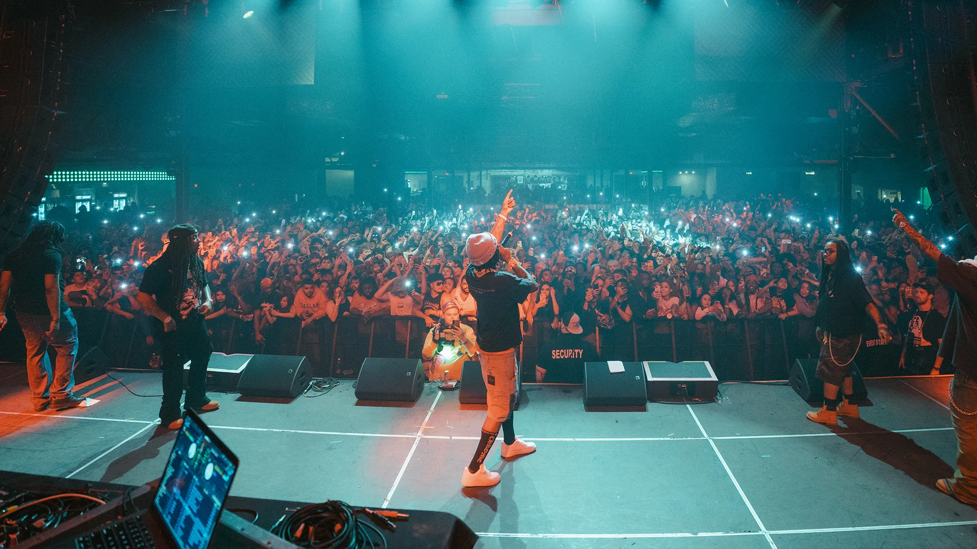 Artist performing on stage with crowd