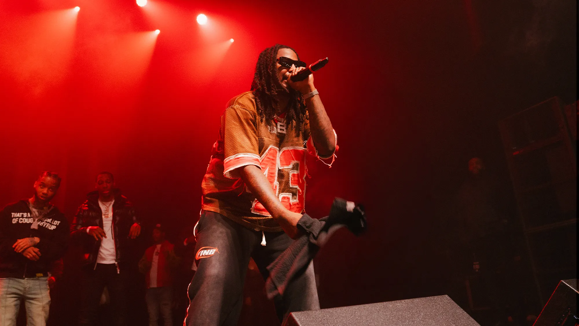 Artist performing with dramatic red lighting